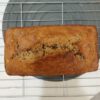 Freshly baked banana bread resting on a cooling rack