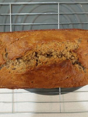 Freshly baked banana bread resting on a cooling rack