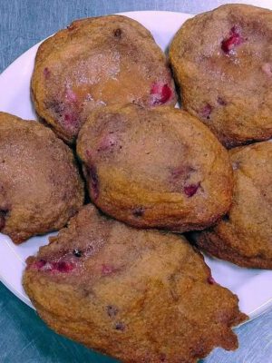 Freshly made strawberry cookies resting on a white plate