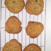 Fresh baked chocolate chip cookies cooling on a baking rack